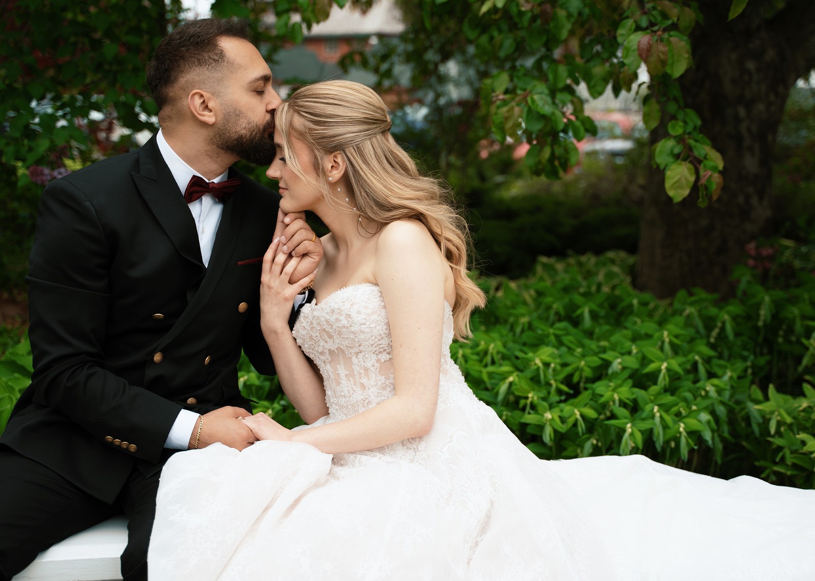 Couple kissing on an elegant staircase at a formal venue