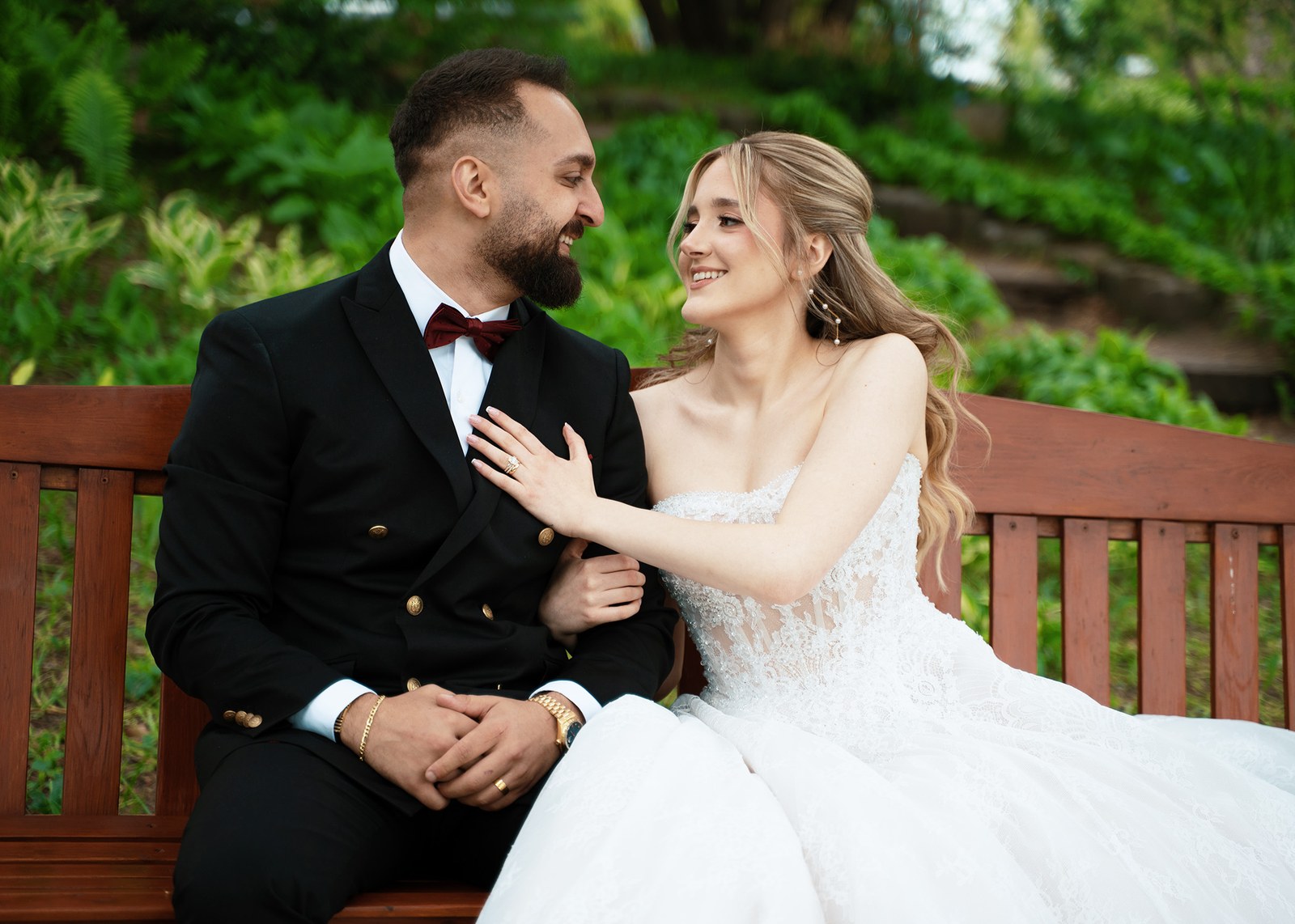 Couple sitting close together, laughing outdoors