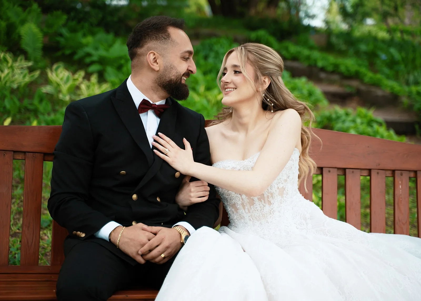 Couple sitting close together, laughing outdoors