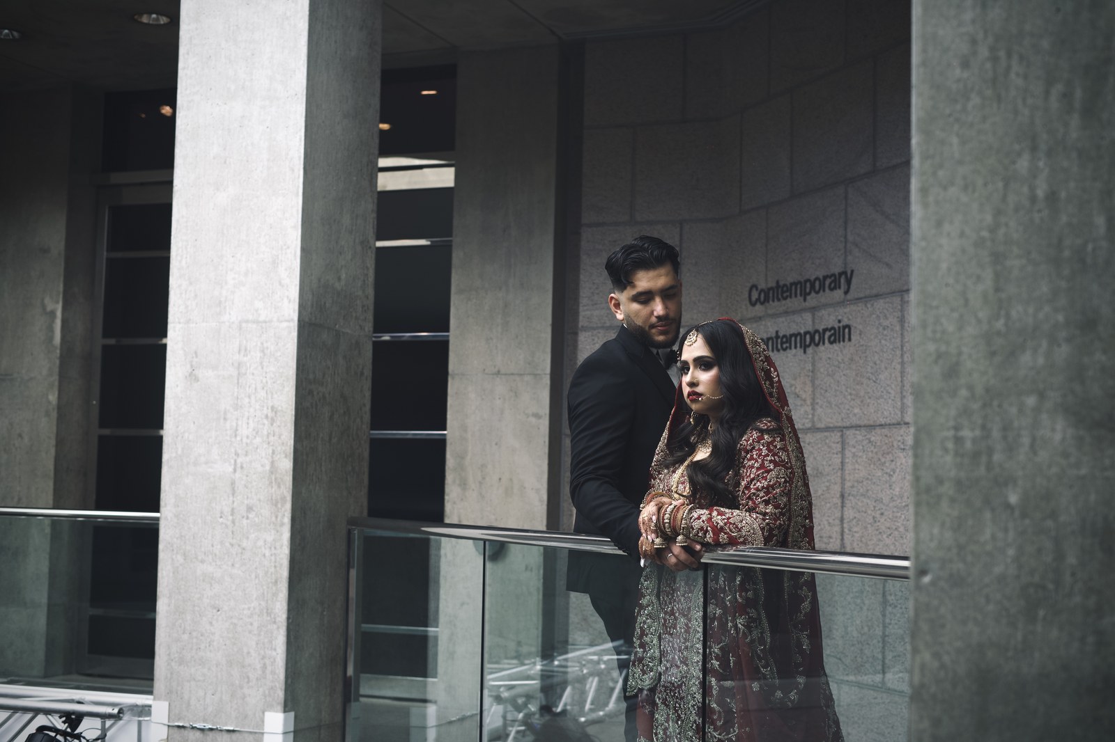 Couple in traditional formal wedding attire in a sunlit hallway, Ottawa cultural wedding photography