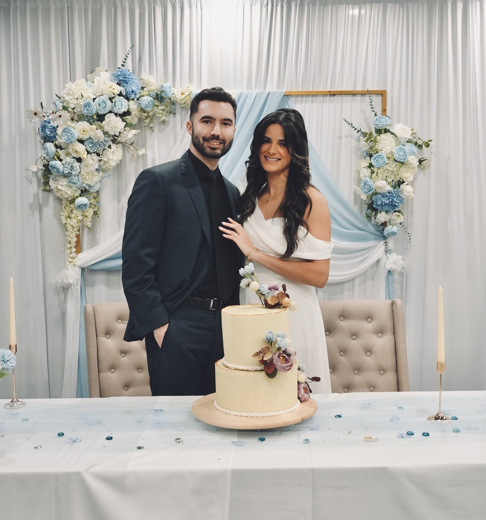 Bride and groom at the sweetheart table with wedding cake