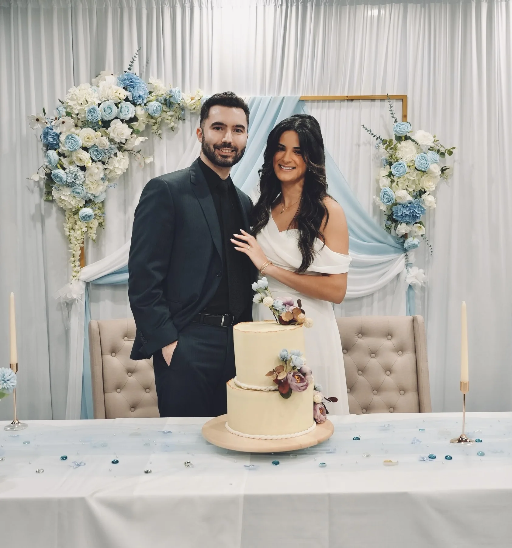 Bride and groom at the sweetheart table with wedding cake
